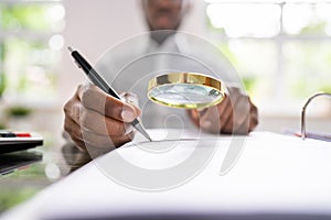 Corporate Auditor Using Magnifying Glass