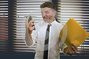 Corporate business and office lifestyle portrait of young stressed and upset executive man working under stress looking angry to