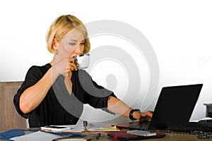 Corporate business portrait of young beautiful and happy woman with blonde hair drinking coffee working relaxed at office laptop c