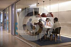 Corporate business team using AV display in meeting cubicle photo