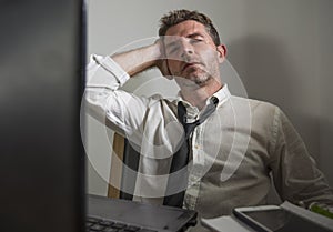 Corporate business work stress - young desperate and frustrated businessman working stressed and overwhelmed at office computer