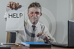 Corporate business worker in stress -  attractive stressed and desperate businessman holding sign crying for help overworked and
