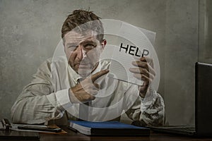 Corporate business worker in stress -  attractive stressed and desperate businessman holding sign crying for help overworked and