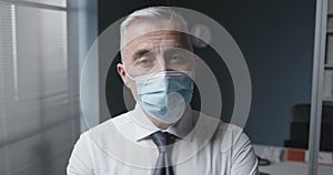 Corporate businessman wearing a surgical mask