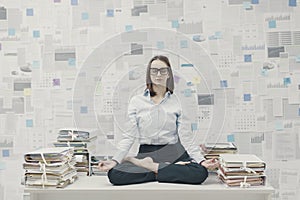 Corporate businesswoman practicing meditation in the office