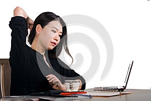 Corporate company portrait of young beautiful and busy Asian Chinese business woman working at office computer desk concentrated i