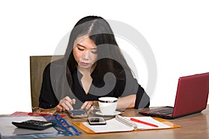 Corporate company portrait of young beautiful and busy Asian Chinese business woman working at office computer desk concentrated i