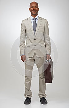 Corporate confidence and success. Portrait of a successful businessman holding a briefcase.