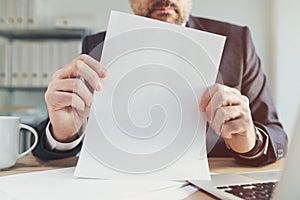 Corporate document report mockup image, businessman holding blank white paper in office