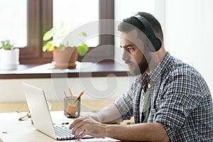 Corporate employee watching training video on his laptop compute photo