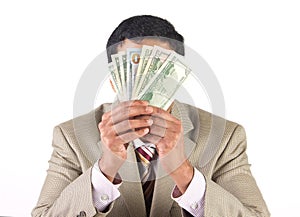 Corporate executive covering face with currency
