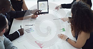 Corporate, finance and business professionals examining papers, information and data while analyzing statistics, graphs