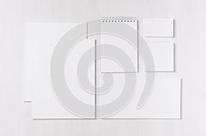 Corporate identity template with black white paper stationery set on soft white elegance wood board.