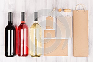 Corporate identity template for wine industry - blank packaging, stationery set with wine bottles on soft white wood background.