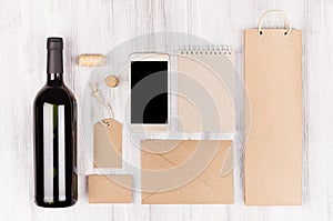 Corporate identity template for wine industry with bottle red wine and wineglass on soft white wood background.