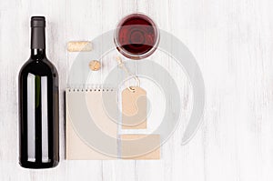Corporate identity template for wine industry with bottle red wine and wineglass on soft white wood background.