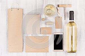 Corporate identity template for wine industry, packaging, stationery, phone, wineglass set with bottle white wine on wood board.