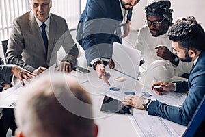 Corporate interracial business team with cheerful leader in a meeting, close up