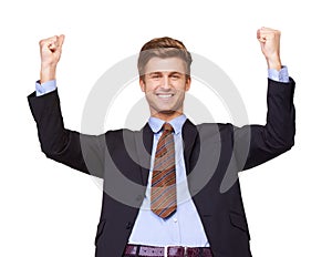 The corporate ladder is mine. Portrait of a handsome young business executive cheering his success.