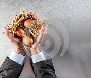 Corporate man hands showing organic eggs for environmental social responsibility