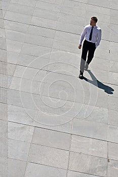 Corporate Man Walking On Pavement