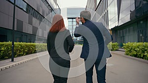 Corporate managers partners man woman people business colleagues businessman businesswoman walk in city back view