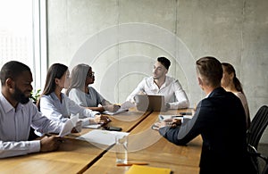 Corporate Meeting. Group Of Multiethnic Business People Having Discussion In Conference Room