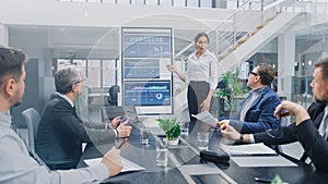 In the Corporate Meeting Room: Female Analyst Uses Digital Interactive Whiteboard for Presentation