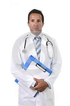 Corporate portrait of confident 40s attractive male medicine doctor with stethoscope with clipboard