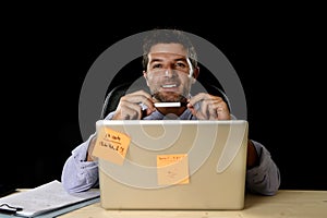 Corporate portrait happy successful businessman smiling at office desk working with laptop computer