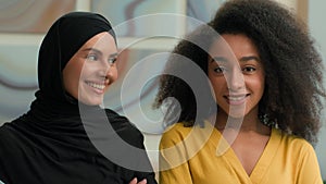 Corporate portrait two multiracial women happy joyful smiling diverse multiethnic businesswomen African American female