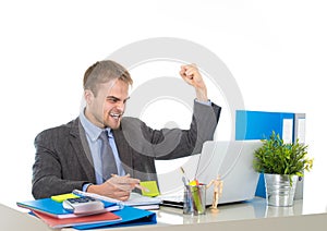 Corporate portrait of young attractive businessman gesturing and celebrating business success excited