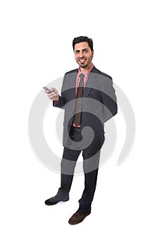 Corporate portrait of young attractive businessman of Latin Hispanic ethnicity smiling using mobile phone