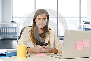 Corporate portrait young attractive businesswoman at office networking on mobile phone