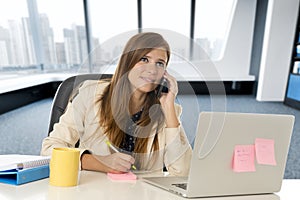 Corporate portrait young attractive businesswoman at office talking on mobile phone