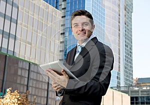 Corporate portrait young businessman working with digital tablet outdoors