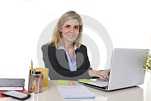 Corporate portrait young happy Caucasian blond business woman working typing on laptop computer