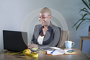 Corporate portrait of young happy and successful black afro American business woman working at modern office smiling cheerful havi