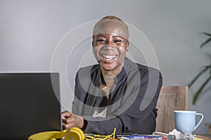 Corporate portrait of young happy and successful black afro American business woman working at modern office smiling cheerful havi