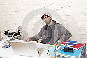 Corporate portrait young hispanic attractive hipster businessman working with computer modern home office