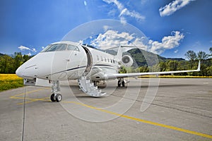 Corporate private jet - plane on runway in mountains