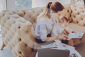 Corporate remote worker feeling engaged in new project while nursing her child