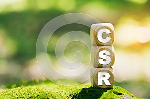 Corporate social responsibility (CSR) and giving back to the community on a green nature background