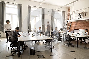 Corporate staff employees working together using computers at co