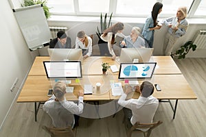 Corporate staff working in office together using computers and t