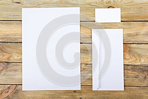 Business card. Corporate stationery set mockup. Blank textured brand ID elements on wooden table. Top view.