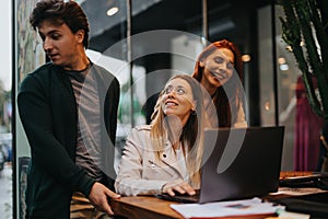 Corporate team analyzing statistics and discussing business income at a coffee bar in the city.