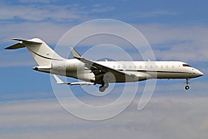 Corporate travel- business jet in blue sky with clouds