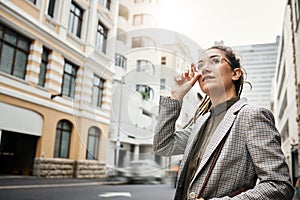 Corporate woman in city, travel and commute to work with buildings, motion blur and waiting for taxi cab. Professional