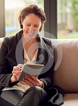 Corporate woman, tablet and happy for work from home, email and communication on couch. Female person, technology and